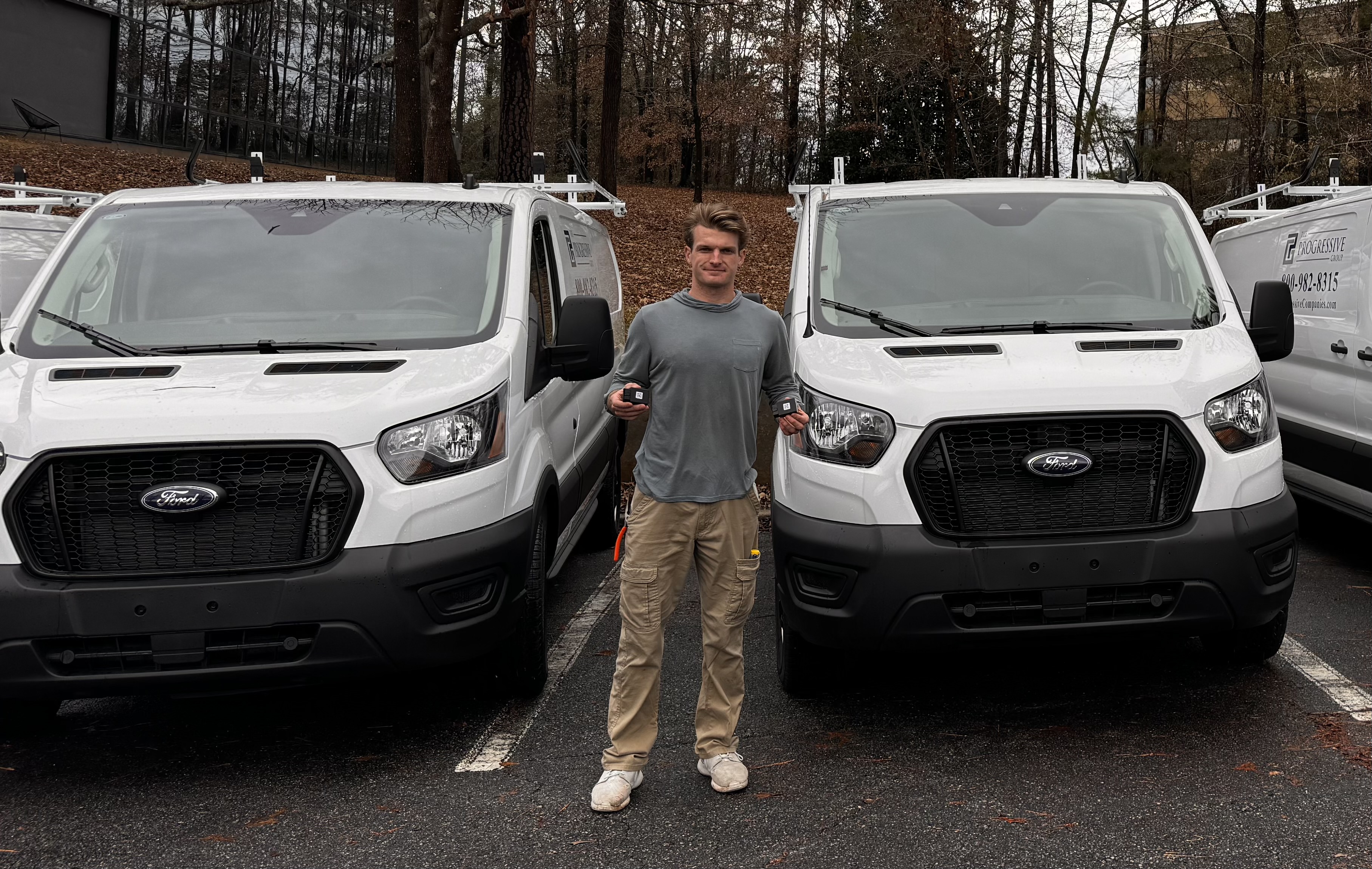 Matthew standing in front of tracked service vans